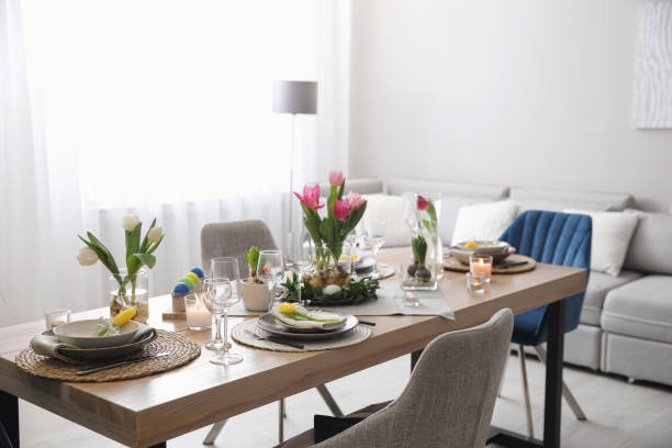 istock Beautiful Easter table setting with beautiful flowers in living room 1307751542