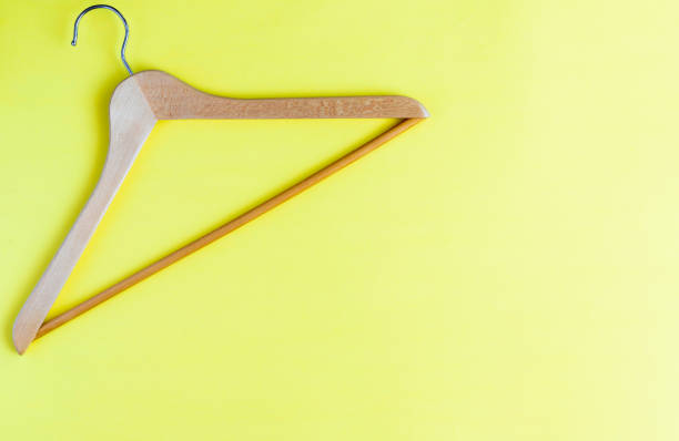 istock Wooden hanger on yellow background 1307752678
