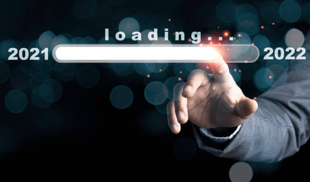 istock Businessman touching to virtual download bar with loading progress bar for New Year's Eve and changing year 2021 to 2022. 1307753355