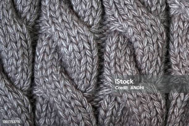 Gray Knitted Fabric With Pigtails Sweater Plaid Scarf Knitted Background Stock Photo - Download Image Now