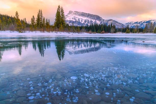 istock Sunrise Reflecting Into A Frozen Cascade Ponds 1307753946