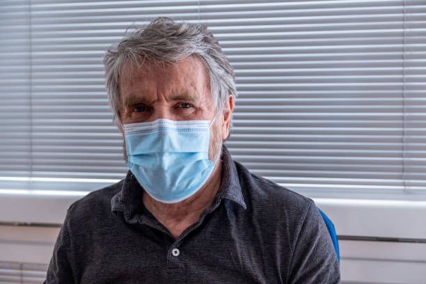 istock Senior Man Smiling under a Mask 1307755258