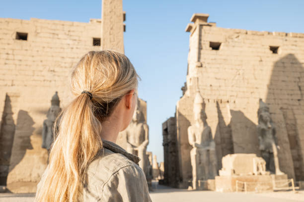 Woman contemplates ancient temple in Luxor