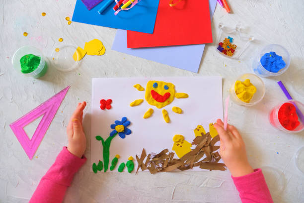 istock Child making spring easter card from colorful paper and clay. Handmade. 1307756007