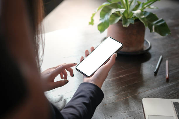 istock Women's hands holding cell telephone blank copy space screen. smart phone with technology concept. 1307757621