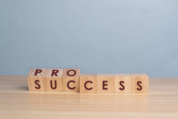 istock Success process symbol. Turned wooden cubes and changed the word 'success' to 'process'. Beautiful wooden table, blue background, copy space. Business, success process concept. 1307760468