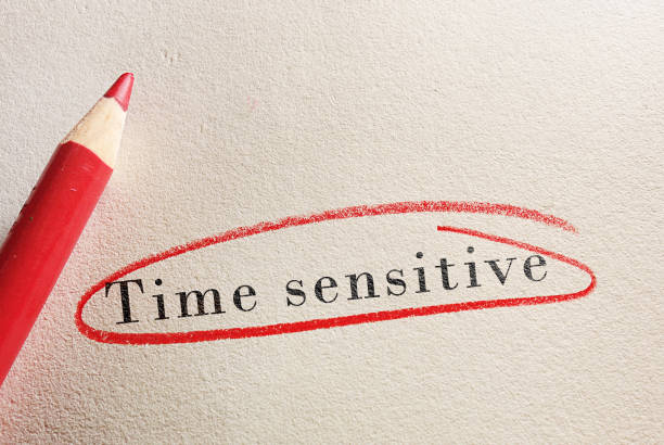 istock Time Sensitive text circled in red pencil on paper 1307760471