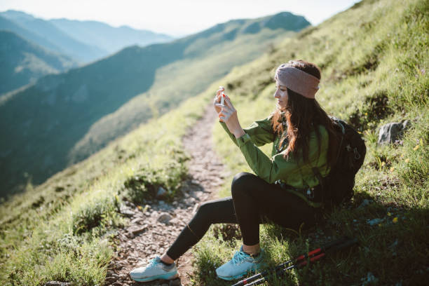 istock Female hiker taking a break and using a phone to take a picture. 1307760496