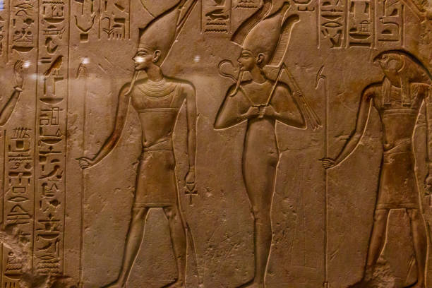 istock Ancient egyptian paintings and hieroglyphs carved on the stone wall 1307760893