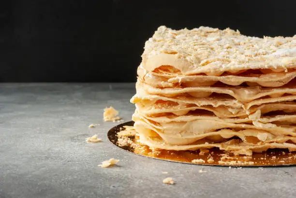 Puff pastry cake Napoleon on a table with space for text