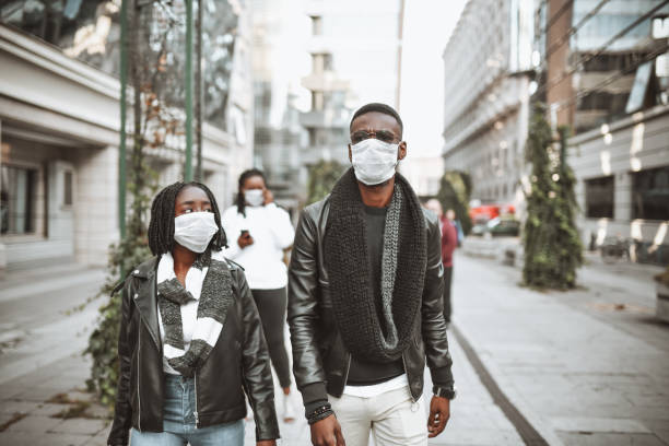 istock African Couple Trying To Protect Themselves With Face Masks While Walking Outside 1307762875