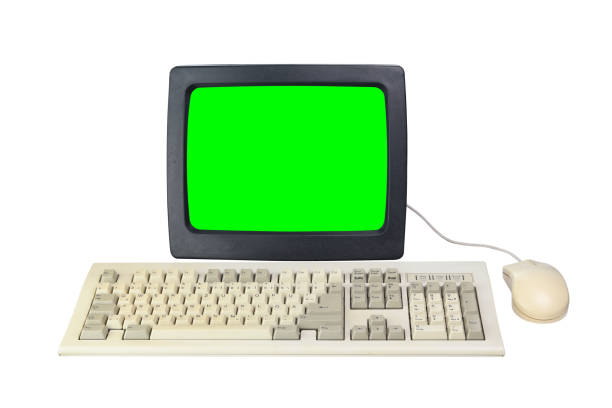 istock Old 1990s computer with green screen for adding videos and images, retro keyboard and mouse isolated on white background. 1307763229