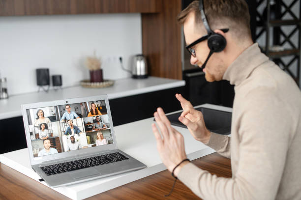 istock Young fit businessman in headset using laptop 1307763315