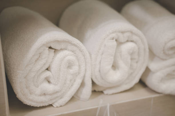 istock Rolled up white towels at hotel. Luxury and hygiene concept 1307764311