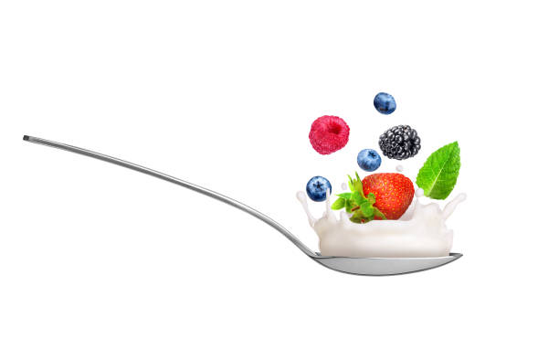 istock berries with white milk sauce in a spoon on a white background 1307766189