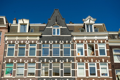 Amsterdam, Netherlands - April 19, 2014: Typical residential buildings in a street of Amsterdam.