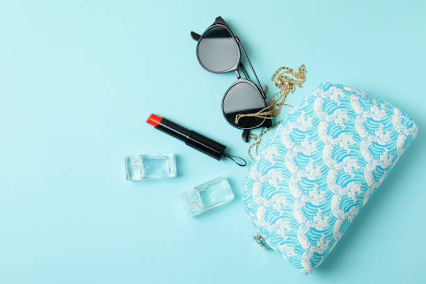 istock Cosmetic bag and female accessories on blue background 1307766408