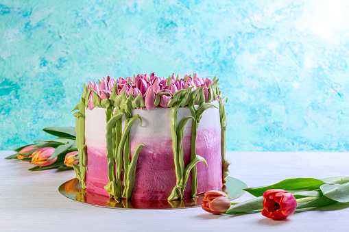Homemade decorate beautiful tulips cakes on white wooden table with copy space. Concept of homemade desserts for holidays, birthday, Valentine's day, wedding
