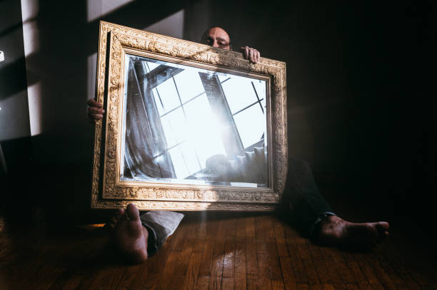 istock Man behind a big antique mirror 1307767968