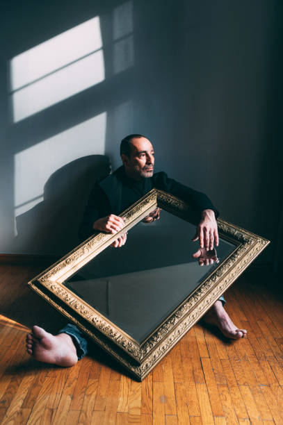 istock Man holding a big antique mirror 1307768012