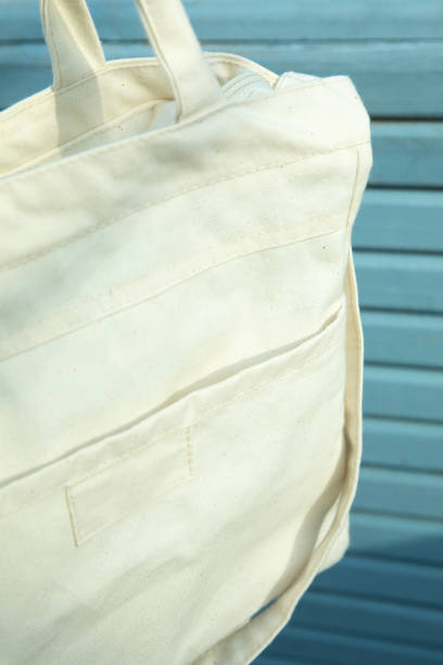 istock Stylish blank eco bag on wooden background 1307768036