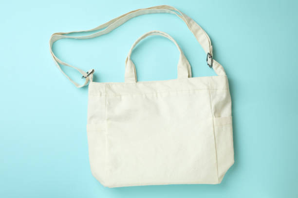 istock Stylish blank eco bag on blue background 1307768197