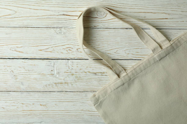 istock Eco bag on wooden background, space for text 1307768316