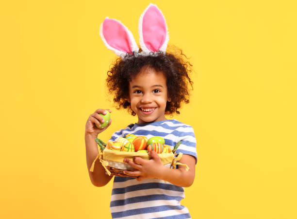 istock Cheerful ethnic kid holding Easter present in hands and laughing 1307768499