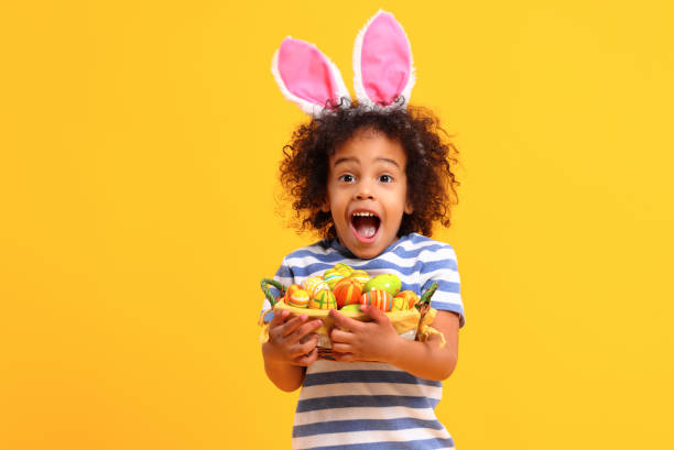 istock Excited sethnic kid holding Easter present in hands and laughing 1307769362