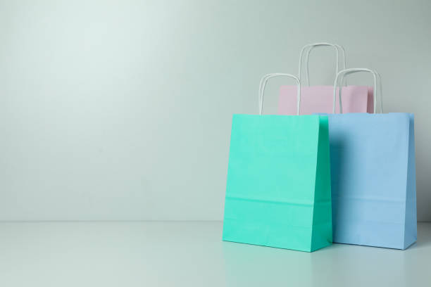 istock Blank colorful paper bags on white background, space for text 1307769910