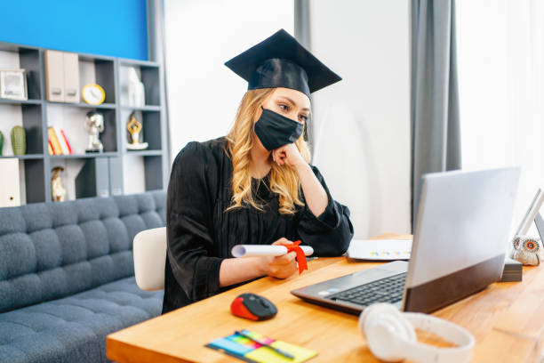istock girl wearing graduation gown 1307770067
