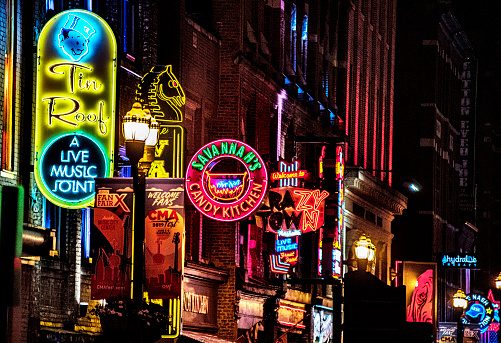 Neon signs up and down Lower Broadway In Nashville draws tourists into Honky Tonks and bars where they can hear live country music. The area is also home to shops, restaurants and other tourist attractions.