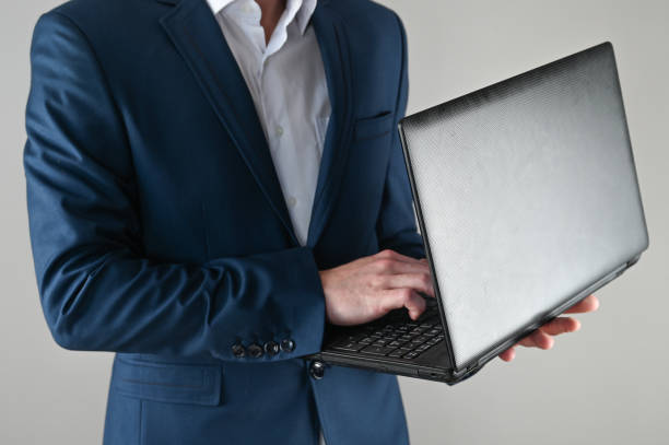 istock A man in a suit is working on a laptop 1307771154