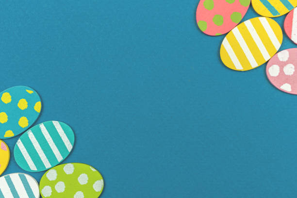 Colorful flat Easter eggs border on a pastel background, photo with place for your text