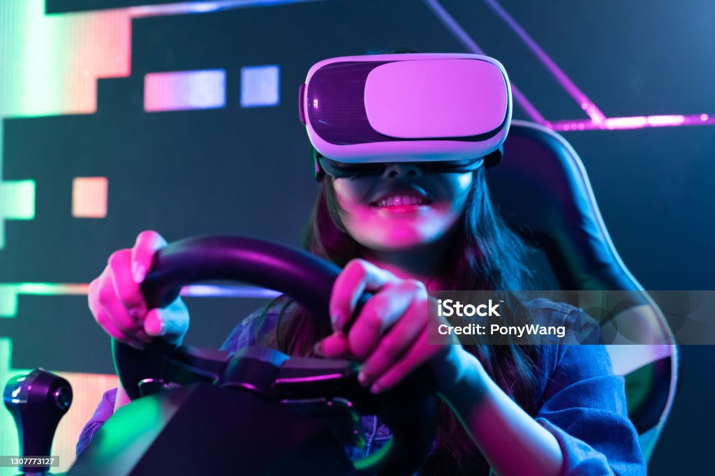 woman play 3D vr game asian woman wears vr glasses and play car racing online video games Video Game Stock Photo