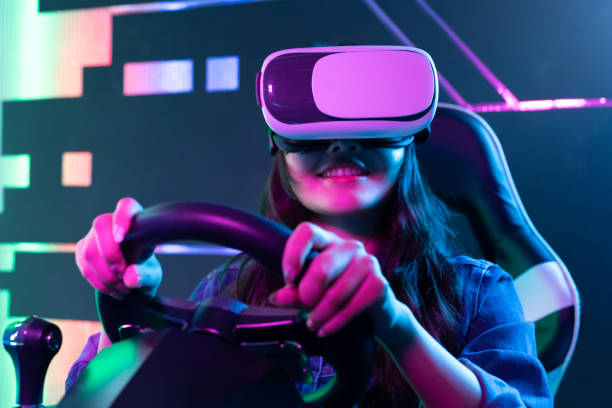 woman play 3D vr game asian woman wears vr glasses and play car racing online video games sense of science and technology stock pictures, royalty-free photos & images