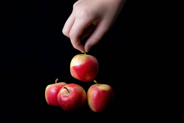 istock A hand is handling a little juicy apple 1307774017