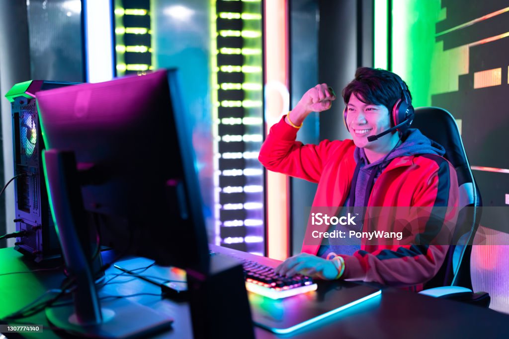 cyber sport gamer win game Young Asian Handsome Pro Gamer Win in Online Video Game with Fist Gesture Asia Stock Photo