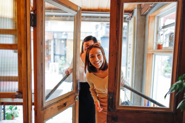 Women walk into the restaurant Two young women open the door and walk into the restaurant walk up restaurant stock pictures, royalty-free photos & images