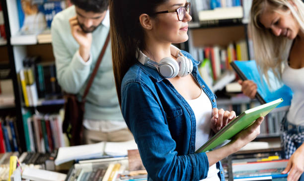 istock Group of college students studying in the school library 1307775656