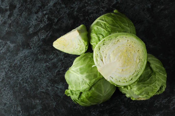 istock Fresh green cabbage on black smoky table 1307776156