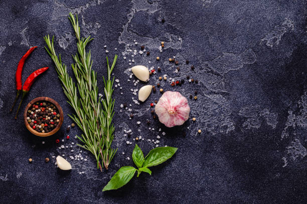 istock Herbs and condiments on black stone background 1307776259