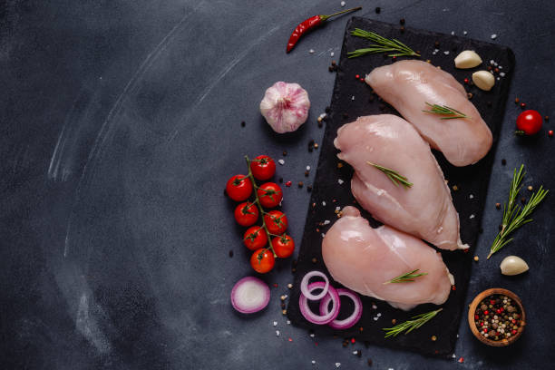 istock Raw chicken fillet with spices and herbs 1307776433