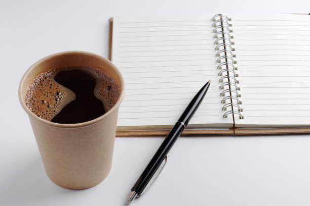 istock Cup of coffee, notepad and pen 1307779132