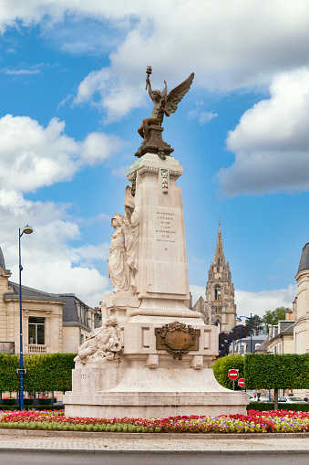 Soissons, France - June 09 2020: War memorial in the center of the Place Fernand Marquigny in front of the Cathedral of Saint-Gervais-et-Saint-Protais.