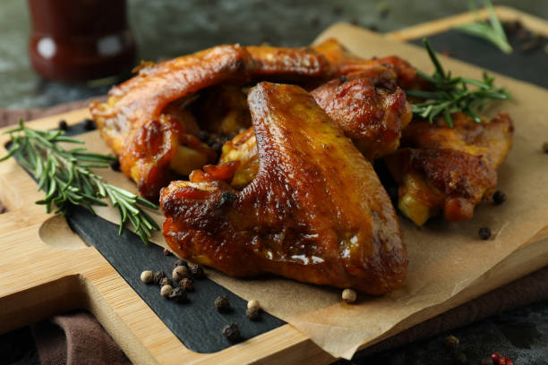 istock Board with baked chicken wings, close up 1307779301