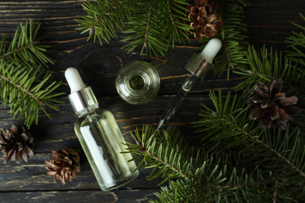istock Aromatherapy concept with pine oil on wooden table 1307781036