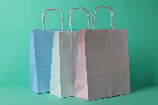istock Blank colorful paper bags on mint background 1307782186