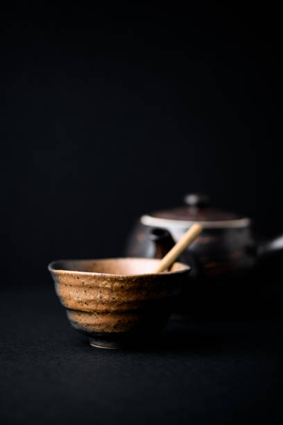 Traditional, handcrafted ceramic on dark background. Soft focus. Close up.