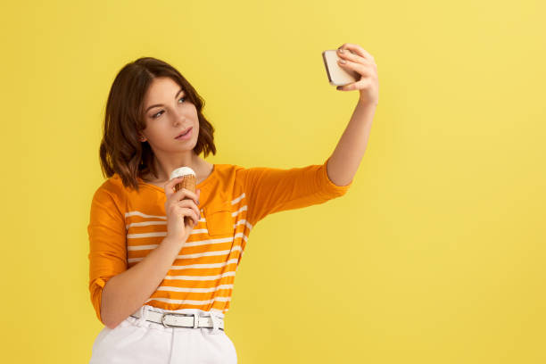 istock woman with vanilla ice cream making selfie 1307787074